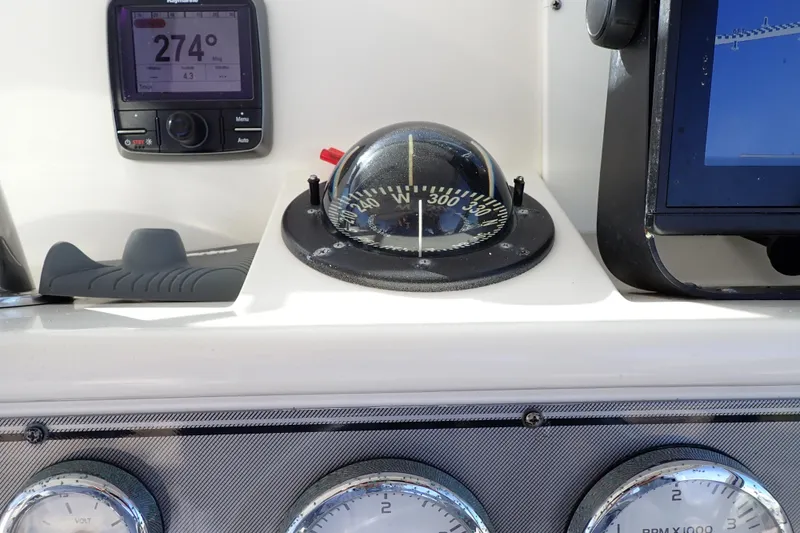 Slide: The Image of Dashboard of 2006 Wellcraft 330 Coastal boat with compass and navigation instruments. - 123