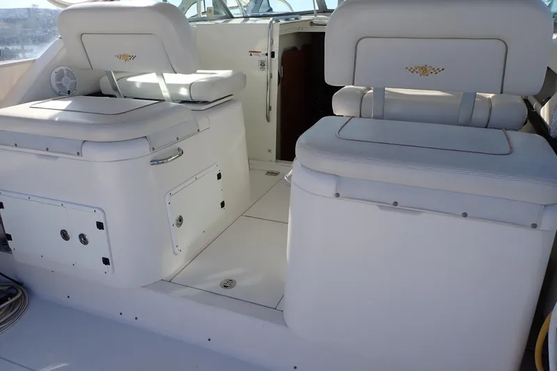 Slide: The Image of 2006 Wellcraft 330 Coastal boat interior with white seating and storage compartments. - 124