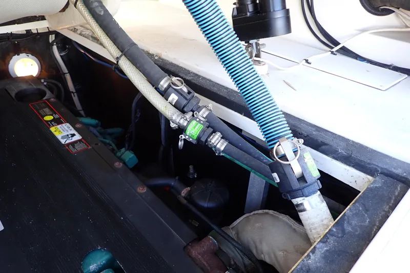Slide: The Image of Engine compartment of 2006 Wellcraft 330 Coastal boat, showing hoses and components. - 128