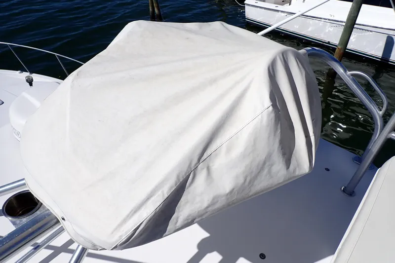 Slide: The Image of Covered helm station on a 2006 Wellcraft 330 Coastal boat, docked by the water. - 13