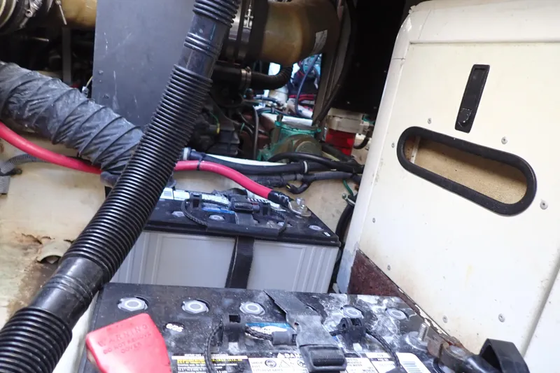 Slide: The Image of Engine compartment of 2006 Wellcraft 330 Coastal, featuring battery and wiring components. - 134