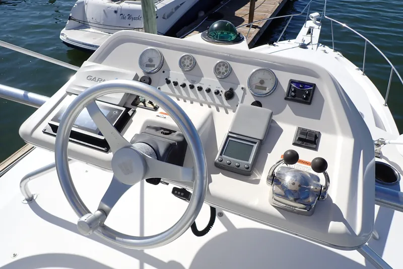 Slide: The Image of Steering console of 2006 Wellcraft 330 Coastal boat with navigation instruments and controls. - 14