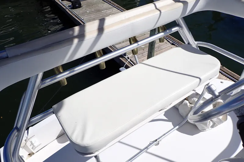 Slide: The Image of 2006 Wellcraft 330 Coastal boat seating area with white cushions and metal railings. - 15