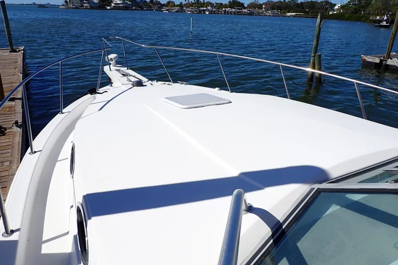 Slide: The Image of 2006 Wellcraft 330 Coastal boat docked by the water on a sunny day. - 21