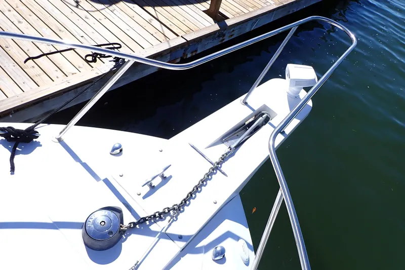 Slide: The Image of Bow of 2006 Wellcraft 330 Coastal boat with anchor and railing at dock. - 23