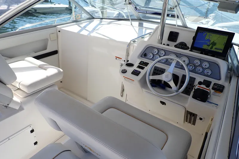 Slide: The Image of 2006 Wellcraft 330 Coastal boat cockpit with steering wheel and navigation system. - 27