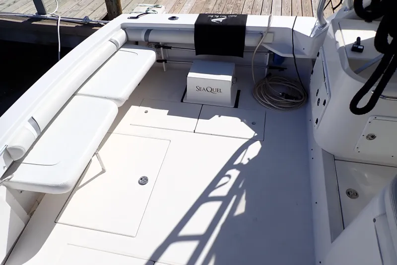 Slide: The Image of 2006 Wellcraft 330 Coastal boat interior with seating and storage, docked at a marina. - 28