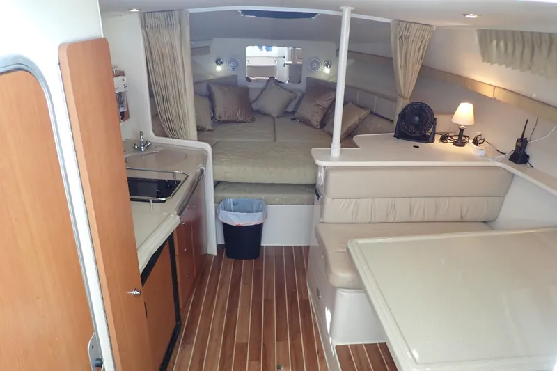 Slide: The Image of 2006 Wellcraft 330 Coastal interior with kitchenette, seating, and cozy sleeping area. - 29