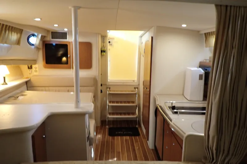 Slide: The Image of Interior of 2006 Wellcraft 330 Coastal boat, featuring kitchen and seating area. - 31