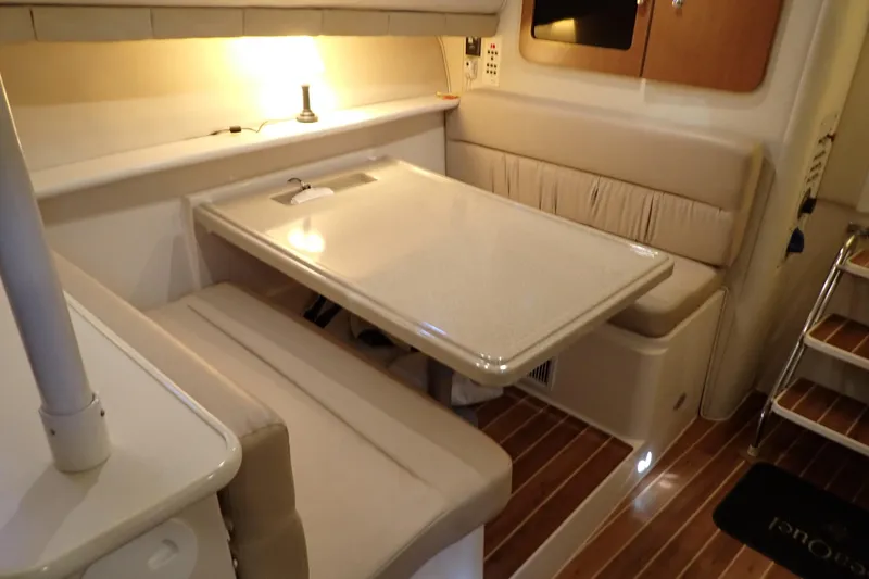 Slide: The Image of 2006 Wellcraft 330 Coastal cabin interior with dining area and ambient lighting. - 34