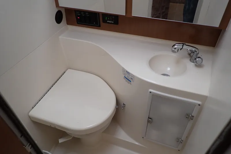 Slide: The Image of 2006 Wellcraft 330 Coastal boat bathroom with toilet and sink. - 36