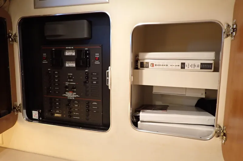Slide: The Image of Electrical panel and storage compartment on a 2006 Wellcraft 330 Coastal boat. - 37