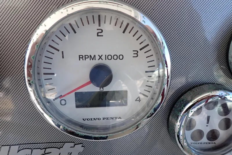 Slide: The Image of Close-up of a 2006 Wellcraft 330 Coastal RPM gauge, displaying Volvo Penta branding. - 39
