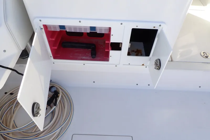 Slide: The Image of Open storage compartments on a 2006 Wellcraft 330 Coastal boat deck. - 44