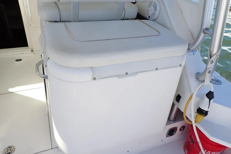 Slide: The Image of 2006 Wellcraft 330 Coastal boat interior with cushioned seating and storage. - 45