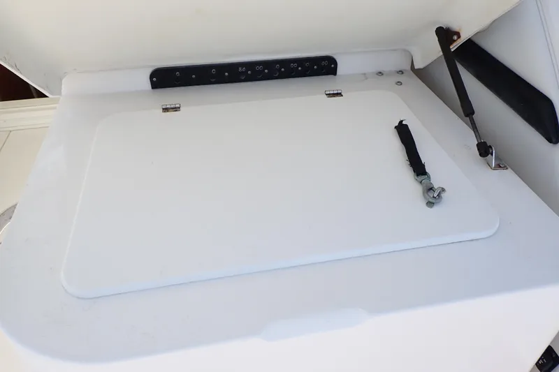 Slide: The Image of 2006 Wellcraft 330 Coastal boat storage compartment with secure latch and hydraulic support. - 46