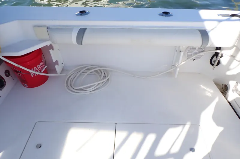 Slide: The Image of 2006 Wellcraft 330 Coastal boat deck with red bucket and coiled rope. - 50