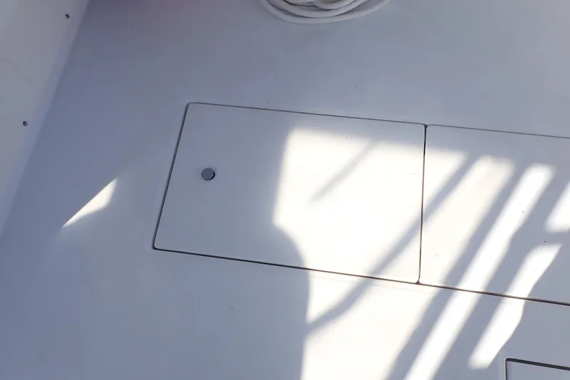 Slide: The Image of Deck of 2006 Wellcraft 330 Coastal boat with storage hatch and shadows. - 51