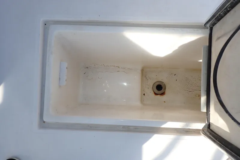 Slide: The Image of Storage compartment on a 2006 Wellcraft 330 Coastal boat, showing interior details. - 52