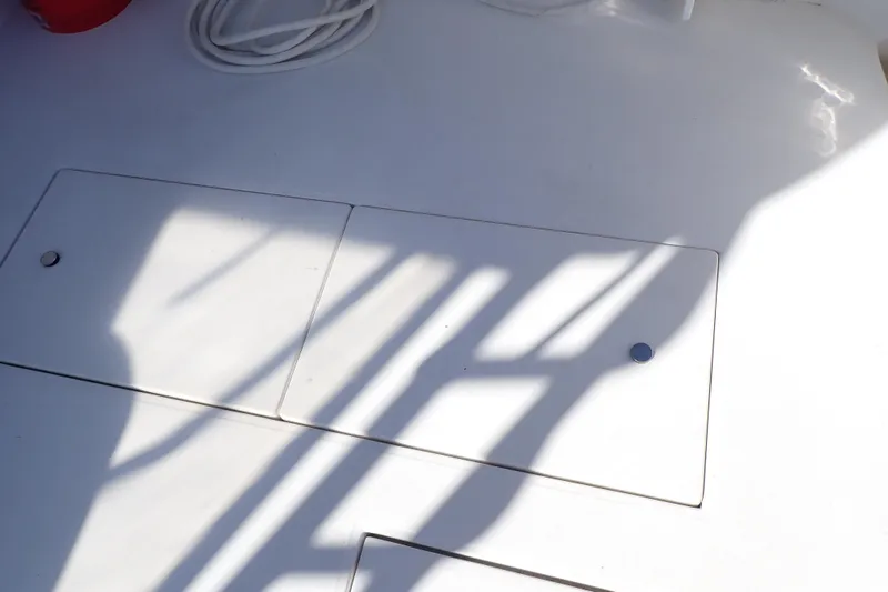 Slide: The Image of Deck of 2006 Wellcraft 330 Coastal boat with shadows and storage compartments. - 53