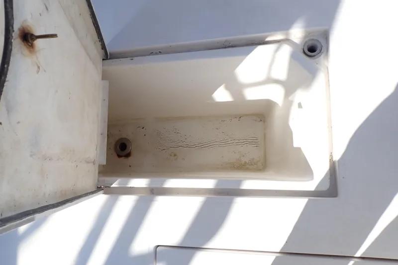 Slide: The Image of Open storage compartment on 2006 Wellcraft 330 Coastal boat, showing interior details. - 54