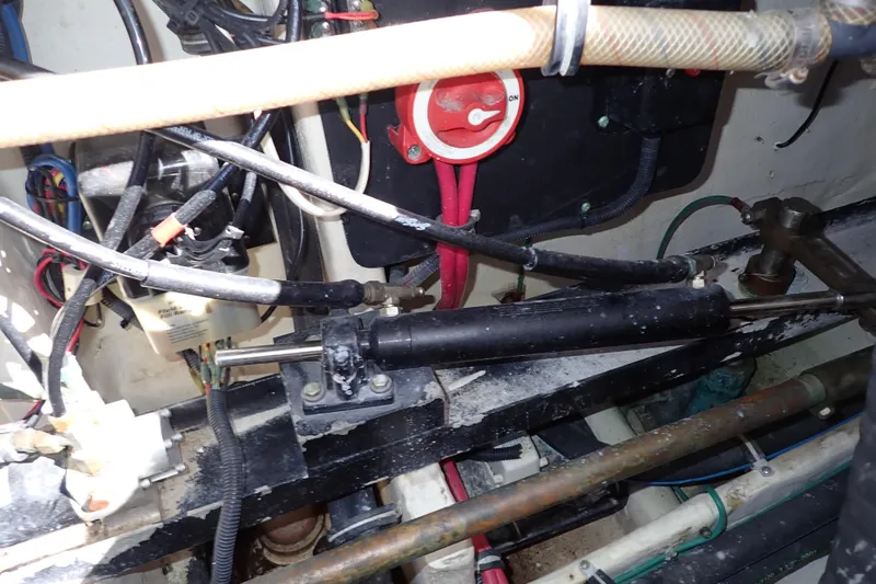 Slide: The Image of Engine compartment of a 2006 Wellcraft 330 Coastal boat, showing hydraulic and electrical components. - 57