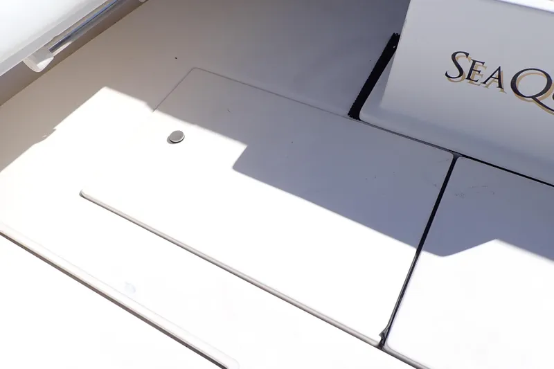 Slide: The Image of 2006 Wellcraft 330 Coastal boat deck with storage compartment and "SeaQ" branding. - 58