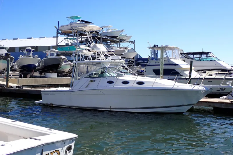 Slide: The Image of 2006 Wellcraft 330 Coastal boat docked at marina with other vessels in background. - 6