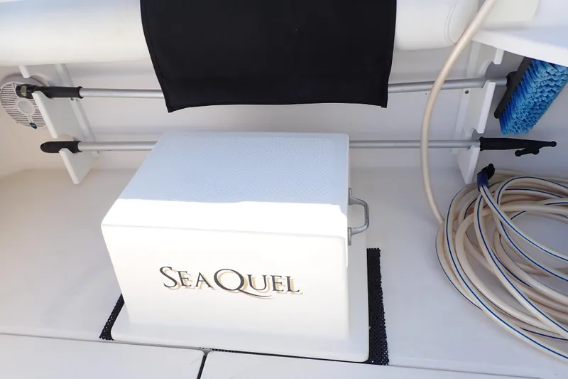 Slide: The Image of 2006 Wellcraft 330 Coastal boat deck with storage box labeled "SeaQuel." - 63
