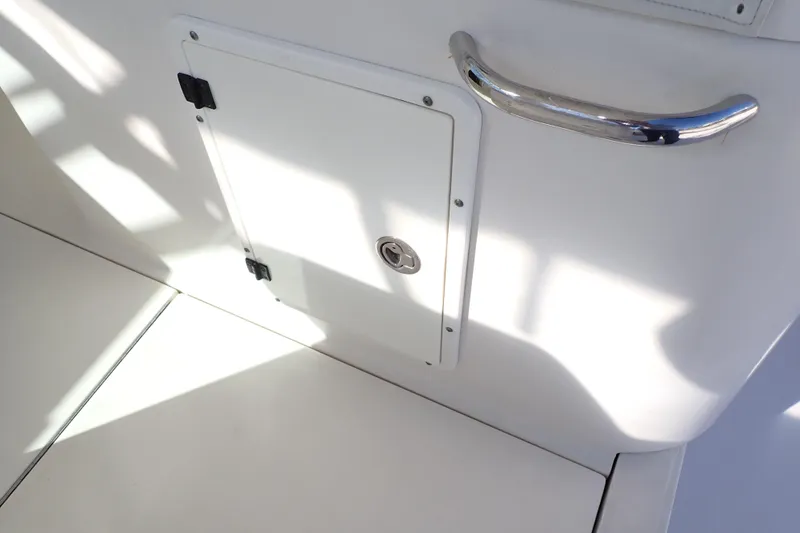 Slide: The Image of 2006 Wellcraft 330 Coastal boat interior with storage compartment and metal handle. - 64