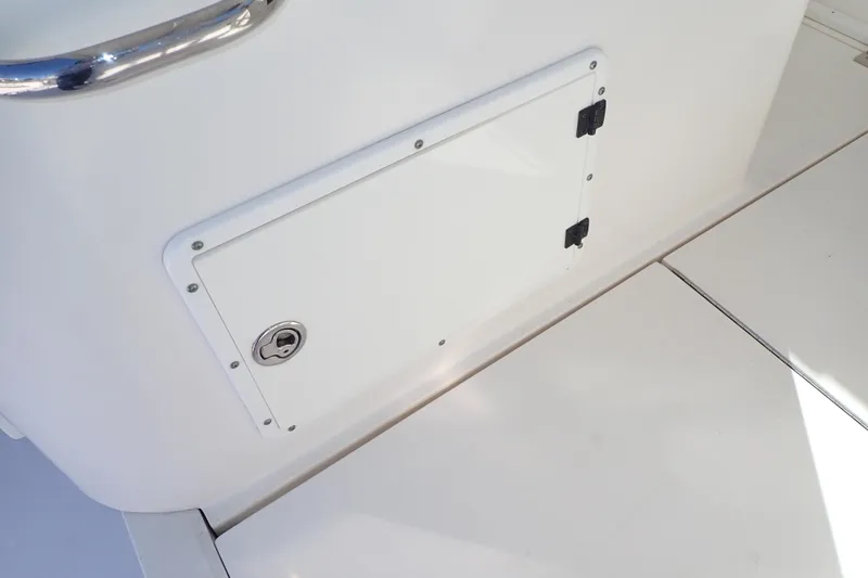 Slide: The Image of 2006 Wellcraft 330 Coastal boat storage compartment with secure latch and sleek design. - 66
