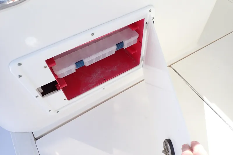 Slide: The Image of Storage compartment on a 2006 Wellcraft 330 Coastal boat, featuring a red interior. - 67