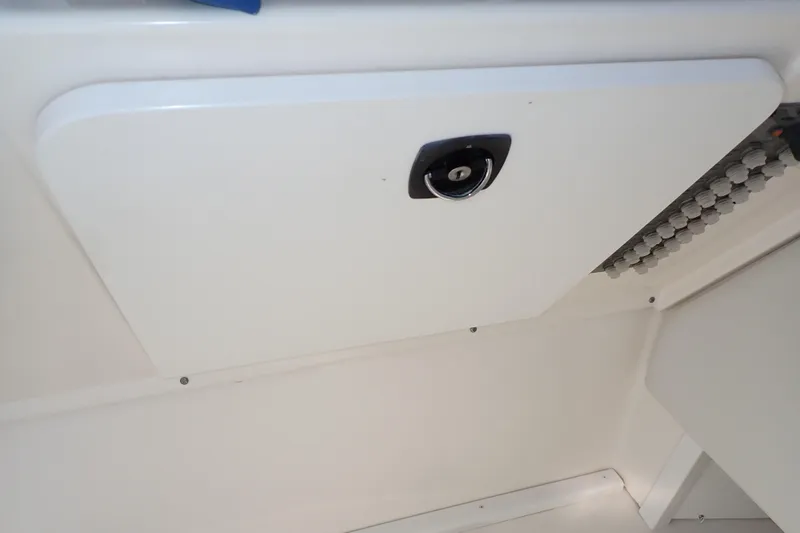 Slide: The Image of 2006 Wellcraft 330 Coastal boat interior storage compartment with latch. - 68