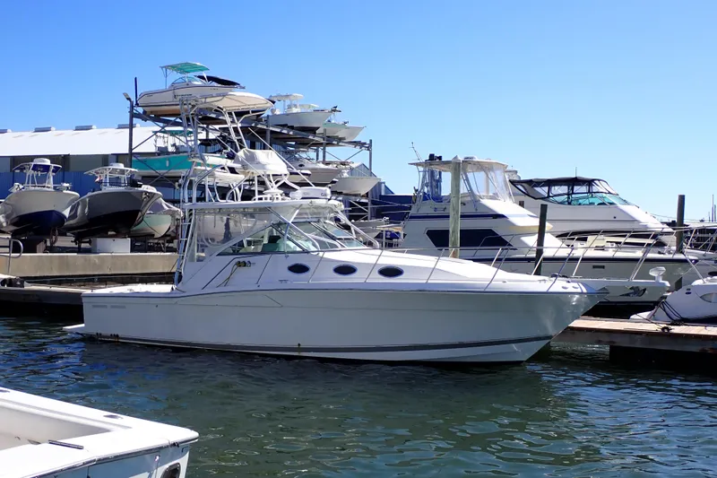 Slide: The Image of 2006 Wellcraft 330 Coastal boat docked at marina with other vessels in background. - 7