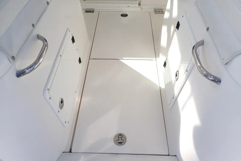 Slide: The Image of 2006 Wellcraft 330 Coastal boat interior with storage compartments and stainless steel handles. - 71