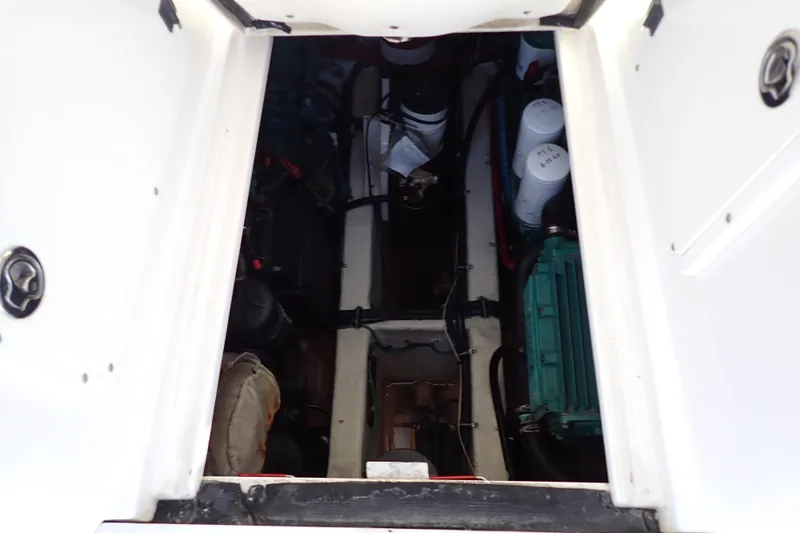 Slide: The Image of Engine compartment of a 2006 Wellcraft 330 Coastal boat, showcasing mechanical components. - 72