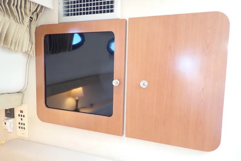 Slide: The Image of Interior of 2006 Wellcraft 330 Coastal with wooden cabinets and control panel. - 76