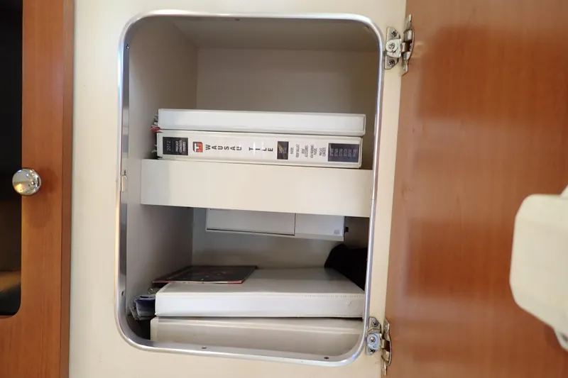 Slide: The Image of Cabinet interior on 2006 Wellcraft 330 Coastal boat with binders and documents. - 80