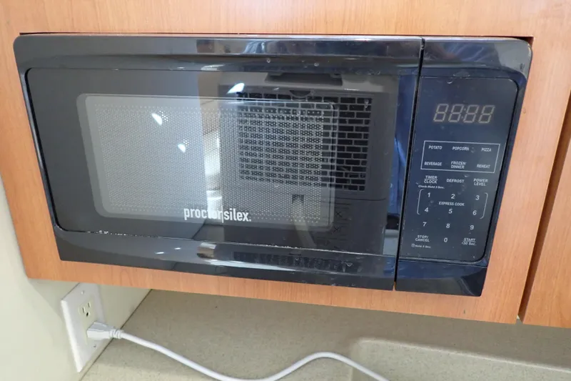 Slide: The Image of Proctor Silex microwave in Wellcraft 330 Coastal boat, 2006 model, mounted in wooden cabinetry. - 81