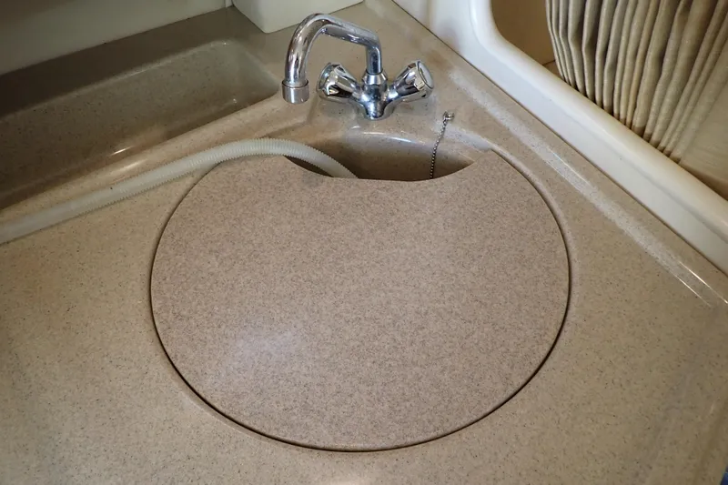 Slide: The Image of 2006 Wellcraft 330 Coastal boat sink with cover and chrome faucet. - 85