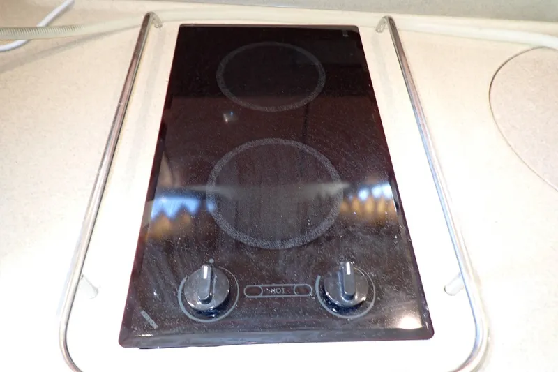 Slide: The Image of Electric stovetop on 2006 Wellcraft 330 Coastal boat, featuring two burners and control knobs. - 87