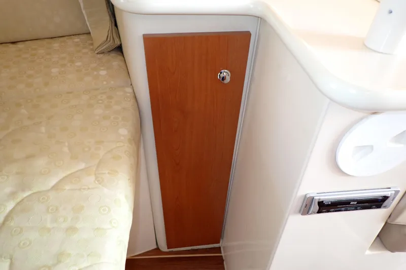 Slide: The Image of 2006 Wellcraft 330 Coastal interior with wood panel and cushioned seating. - 96