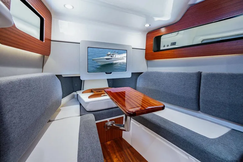 Slide: The Image of Manufacturer Provided Image: Luxurious interior of 2026 Pursuit S 388 Sport boat with modern seating and wooden accents. - 14