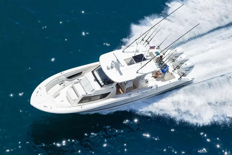 Slide: The Image of Manufacturer Provided Image: 2026 Pursuit S 388 Sport boat cruising on sparkling blue water. - 2