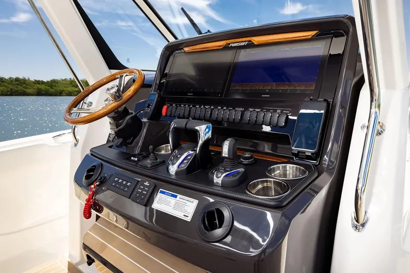 Slide: The Image of Manufacturer Provided Image: Helm of 2026 Pursuit S 388 Sport boat with advanced controls and navigation displays. - 9