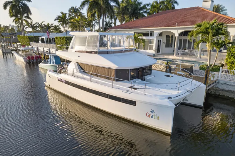 Slide: The Image of 2024 Leopard 46 Powercat yacht docked by a luxurious waterfront home. - 108