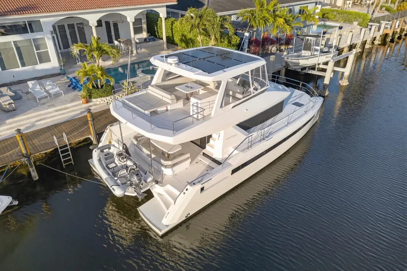 Slide: The Image of 2024 Leopard 46 Powercat yacht docked by waterfront home, showcasing modern design. - 109