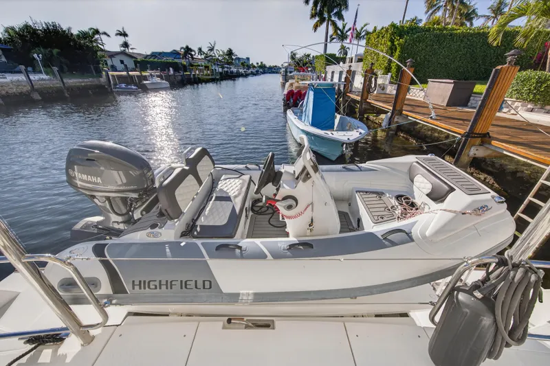 Slide: The Image of 2024 Leopard 46 Powercat with Highfield tender docked by a scenic waterfront. - 12