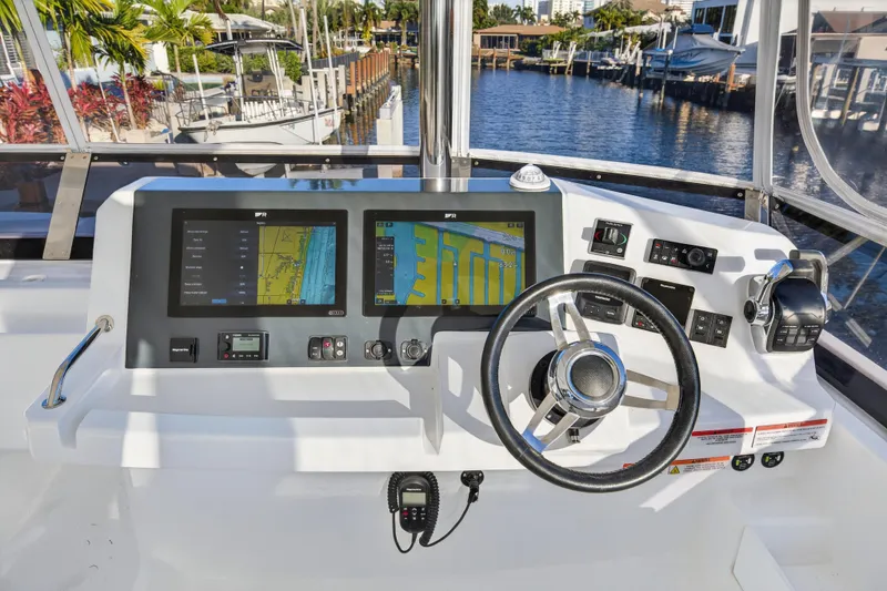 Slide: The Image of Helm of 2024 Leopard 46 Powercat with dual navigation screens and steering wheel. - 19