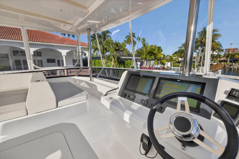 Slide: The Image of 2024 Leopard 46 Powercat helm with modern navigation displays and luxurious seating. - 24